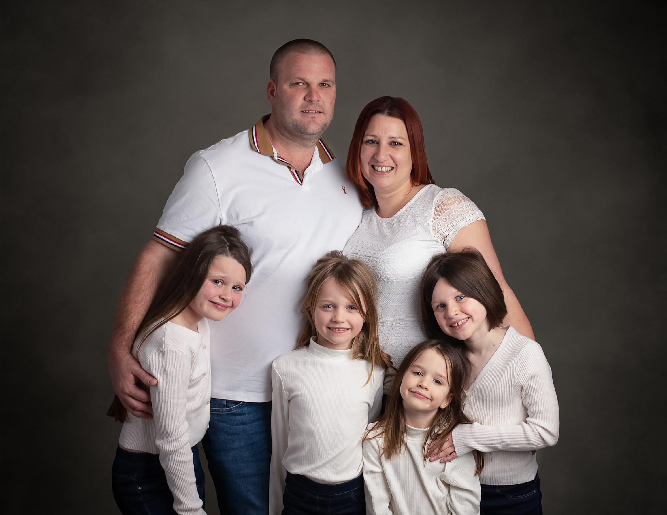 Family standing together in white tops during their family photo shoot whitchurch by newborn photographer Basingstoke Hampshire