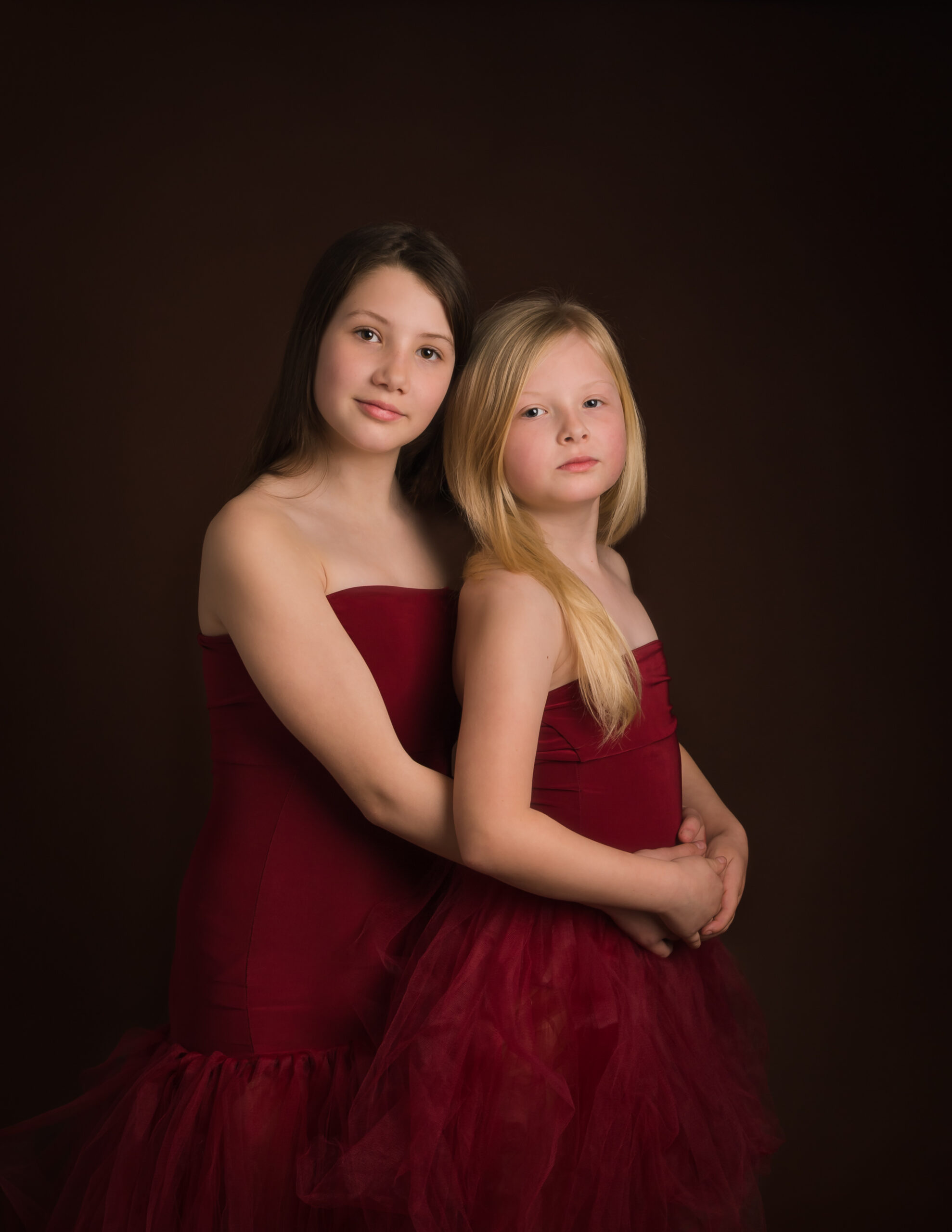 two girls dressed in red by family photographer in basingstoke hampshireWhitchurch Hampshire