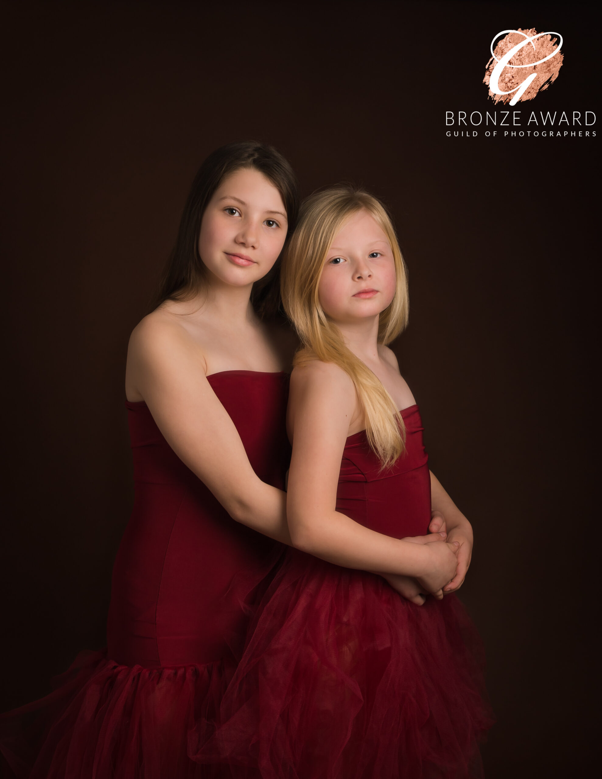 award winning photo of two girls togther for a blog about Prepare Your Children for a Studio Photoshoot
